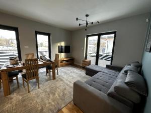a living room with a couch and a table at Sosnówka - Wypoczynek in Sosnówka