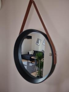 a mirror reflecting a living room with a couch at Cappuccino in Tomaszów Lubelski