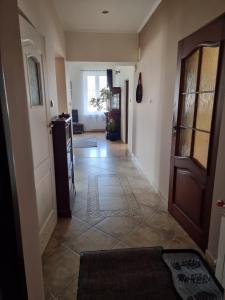 a hallway of a home with a door and a tile floor at Cappuccino in Tomaszów Lubelski