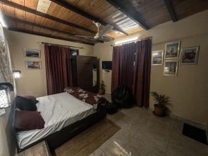 a bedroom with a bed in the middle of it at Karvaan B&B - 2bhk Homestay in Pālampur