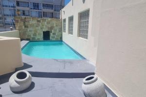 a swimming pool on the side of a building at Ocean Escape in Strand