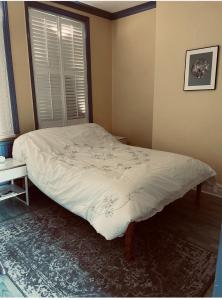 a bed in a room with a window at Norfolk Home On Hunstanton Beach Promenade in Hunstanton