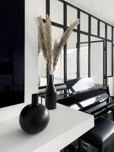 a black vase sitting on a white table at RARE 75m2 Parisian apartment, breathtaking views! in Paris