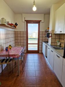 a kitchen with a table and a table and chairs at DOMUS DIVI - Eur Torrino in Rome