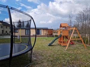 a playground with a slide and a swing set at Apartmán Andrea in Červená Voda