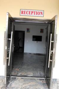 an open elevator door in a building with a evacuation sign at STARSAPPHIRE LUXURY HOTELS LTD 