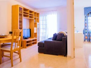 a living room with a couch and a dining room table at Live Sunset Callao in Callao Salvaje