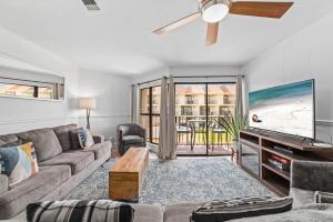 a living room with a couch and a tv at Gulfside Townhomes 9 in Gulf Shores