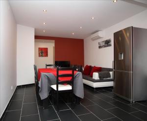 a dining room with a table and a couch at Geneve Old Town Apartment in Albufeira +14 photos