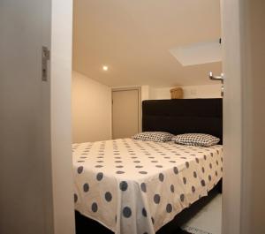 a bedroom with a bed with a polka dot bedspread at Geneve Old Town Apartment in Albufeira