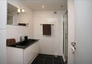 a bathroom with a sink and a shower at Geneve Old Town Apartment in Albufeira
