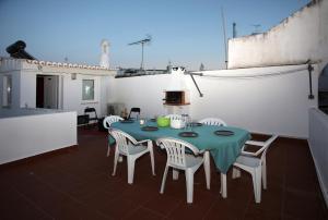 a green table and chairs on a balcony at Geneve Old Town Apartment in Albufeira