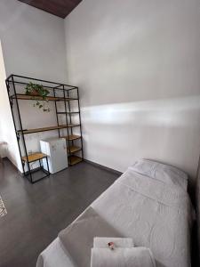 a bedroom with a bed and a book shelf at Pousada Canto Verde in Serra do Cipo