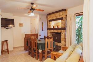 a living room with a table and a fireplace at Apart Vitraux in Las Gaviotas