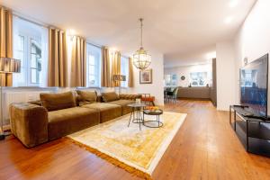a living room with a couch and a table at LIT LIVING Weinheim Altstadt - Boutique Apartments - Parking in Weinheim
