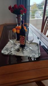 a bottle of wine and two glasses on a table at Albanian Gem in Kuçovë in Kuçovë