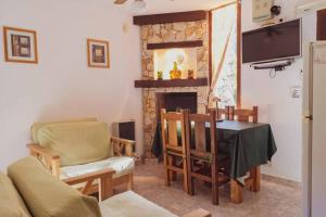 a living room with a table and a fireplace at Apart Vitraux in Las Gaviotas