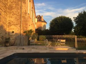 a pool in front of a building with a fence at CHATEAU DE SAINTE ORSE in Sainte-Orse
