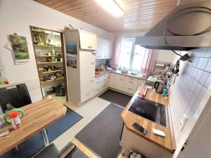 a large kitchen with a table and a refrigerator at Make yourself at home in Vaihingen an der Enz
