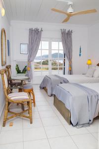 A bed or beds in a room at Aroura Homes 4BR Beachfront Villa