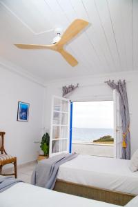 A bed or beds in a room at Aroura Homes 4BR Beachfront Villa