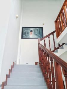 a picture of a man on a television on a stairway at Villa Wasana - Galle in Galle