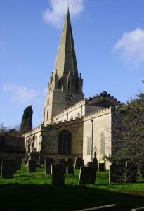 an old church with a steeple and a cemetery at Pinewood #Edwinstowe in Edwinstowe