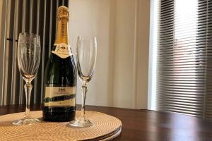 a bottle of champagne and two wine glasses on a table at Pinewood #Edwinstowe in Edwinstowe