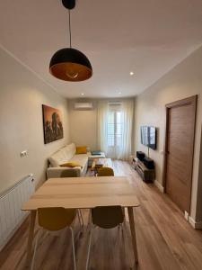 a living room with a couch and a table at PRECIOUS AND ORIGINAL APARTMENT CENTER in Cádiz