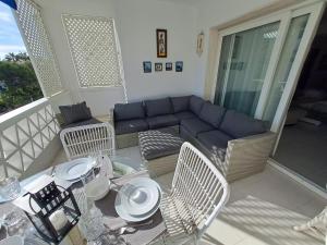 a patio with a couch and a table and chairs at Luxury Apartment in Playas del Duque , Puerto Banus by Holidays & Home in Marbella