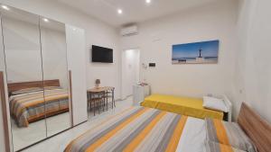 1 dormitorio con 2 camas y TV. en Locazione turistica adriatico en Bari
