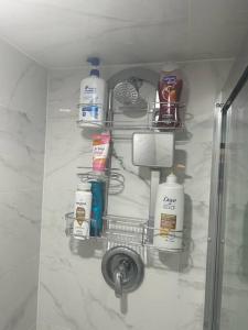 a rack with toiletries on a wall in a bathroom at 2 Bedroom private apartment with private entrance in Brampton