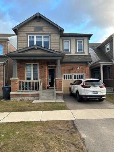 a house with a car parked in front of it at 2 Bedroom private apartment with private entrance in Brampton