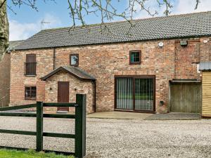 a brick house with a fence in front of it at 3 Bed in Tollerton 87290 in Tollerton