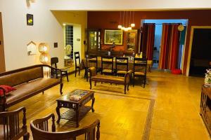 a living room with couches and a dining room at Shangri-La Valley Retreat (3bhk) Luxury Villa, Kjt in Karjat