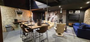 a living room with a table and a couch at PADDOCK 24 Arnage - Loft Le Mans in Arnage
