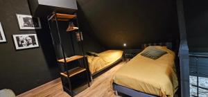 a bedroom with two beds and a mirror at PADDOCK 24 Arnage - Loft Le Mans in Arnage +24 photos