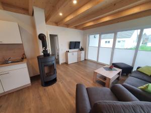 a living room with a couch and a wood stove at Ferienhäuser Prüm in Prüm