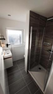 a bathroom with a shower and a sink at Ferienhaus mit Alpenpanorama in Deggenhausertal