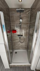a shower with a shower head in a bathroom at Ferienhaus mit Alpenpanorama in Deggenhausertal
