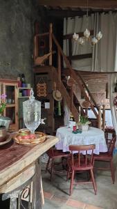 a kitchen with a table and chairs and a staircase at Hostel da Jô in Chapada dos Guimarães