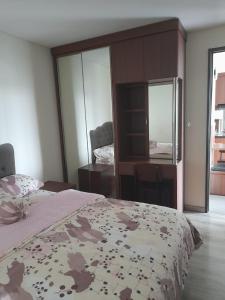 a bedroom with a bed and a desk and a mirror at ICON ROOM 2 Bedroom in South Tangerang +4 photos