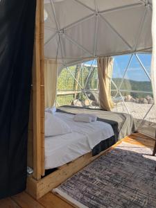 a bedroom with a bed in a tent at Stone Rose Glamping & Apartments in Tivat +59 photos