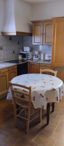 uma cozinha com uma mesa com uma toalha de mesa em Maison en pierre de taille em Petreto-Bicchisano