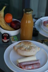 a plate of food with a pita and fruit on a table at Zambujal Suites in Sesimbra