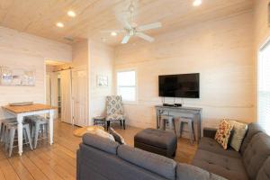 a living room with a couch and a table at Beach Bungalow - 2 Suns in Port Aransas