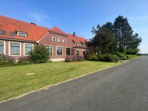 a large brick house with a road in front of it at Dreckerhook, oasis to slow down! in Raesfeld