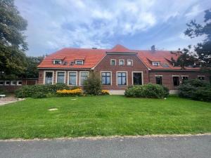 a large brick house with a green yard at Dreckerhook, oasis to slow down! in Raesfeld