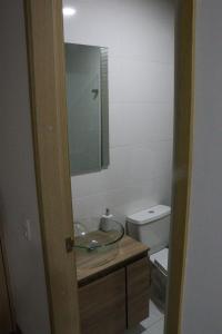 a bathroom with a sink and a toilet at Aparta Estudio Norte Bogotá in Bogotá
