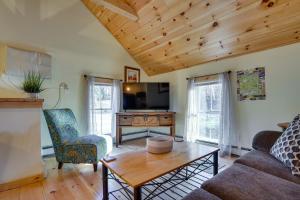 a living room with a couch and a tv at Inviting Chittenden Apartment Near Pico Mountain! in Chittenden
